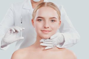 A woman and a cosmetic expert posing with a preventative filler