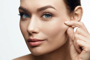 A woman pinching her face