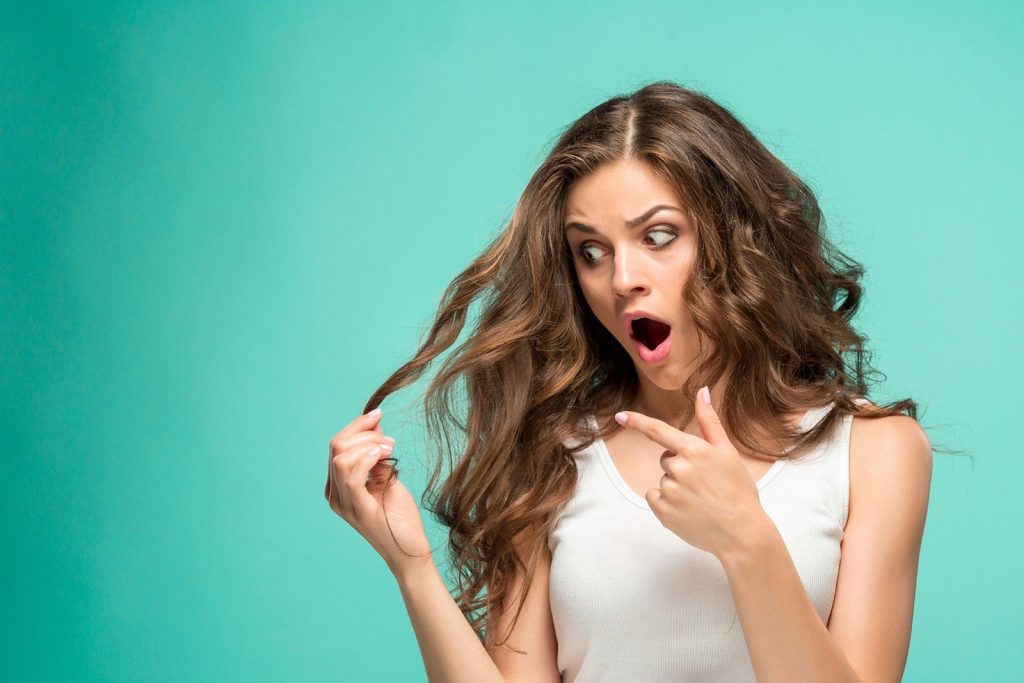 A person holding a lock of her hair